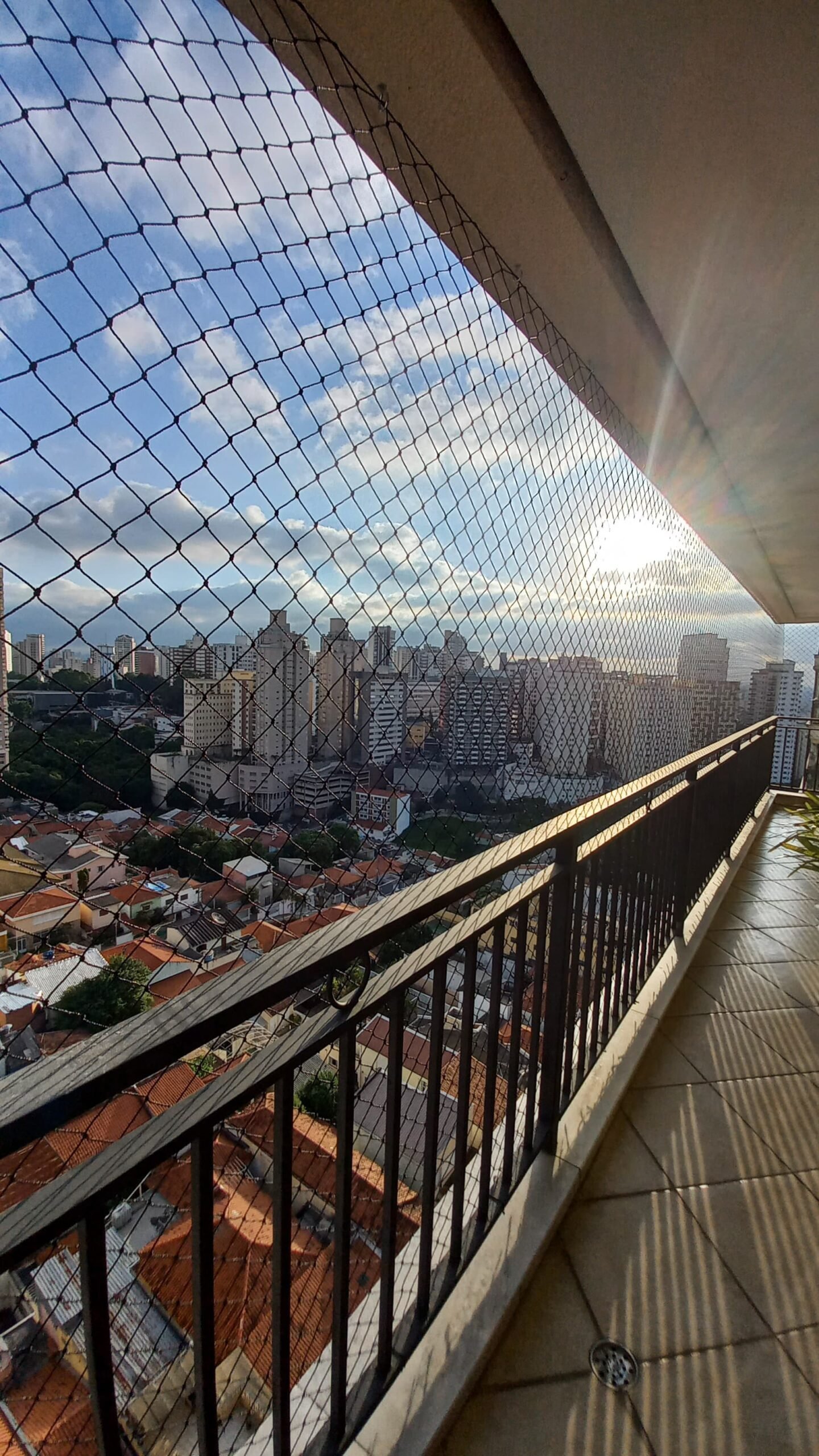 Rede de proteção instalada em sacada com vista de São Paulo